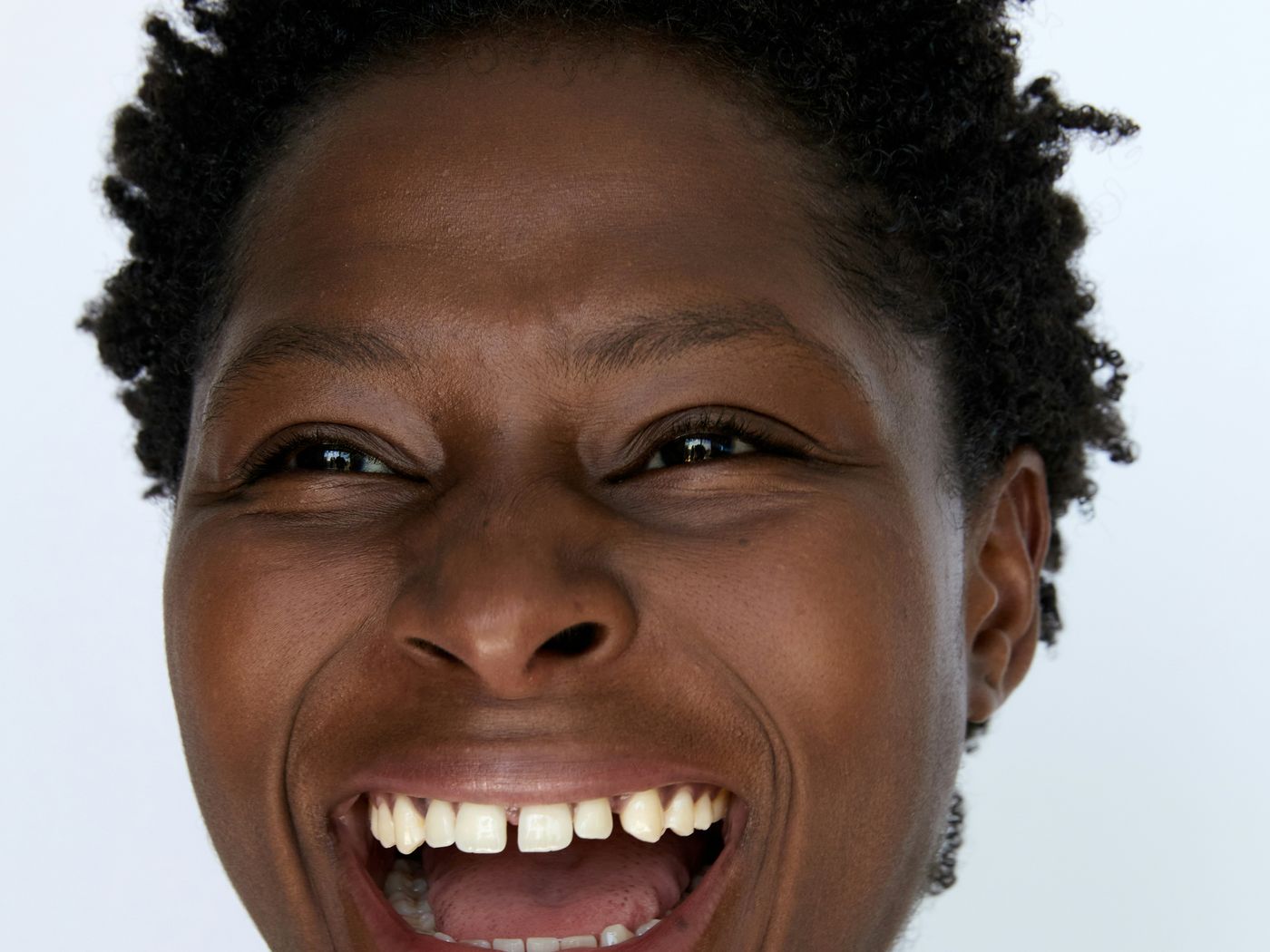 A woman laughing freely and confidently